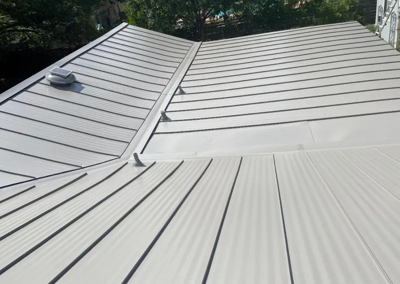 Solar attic fan installed on a metal roof for Roof Ventilation in Wedgefield