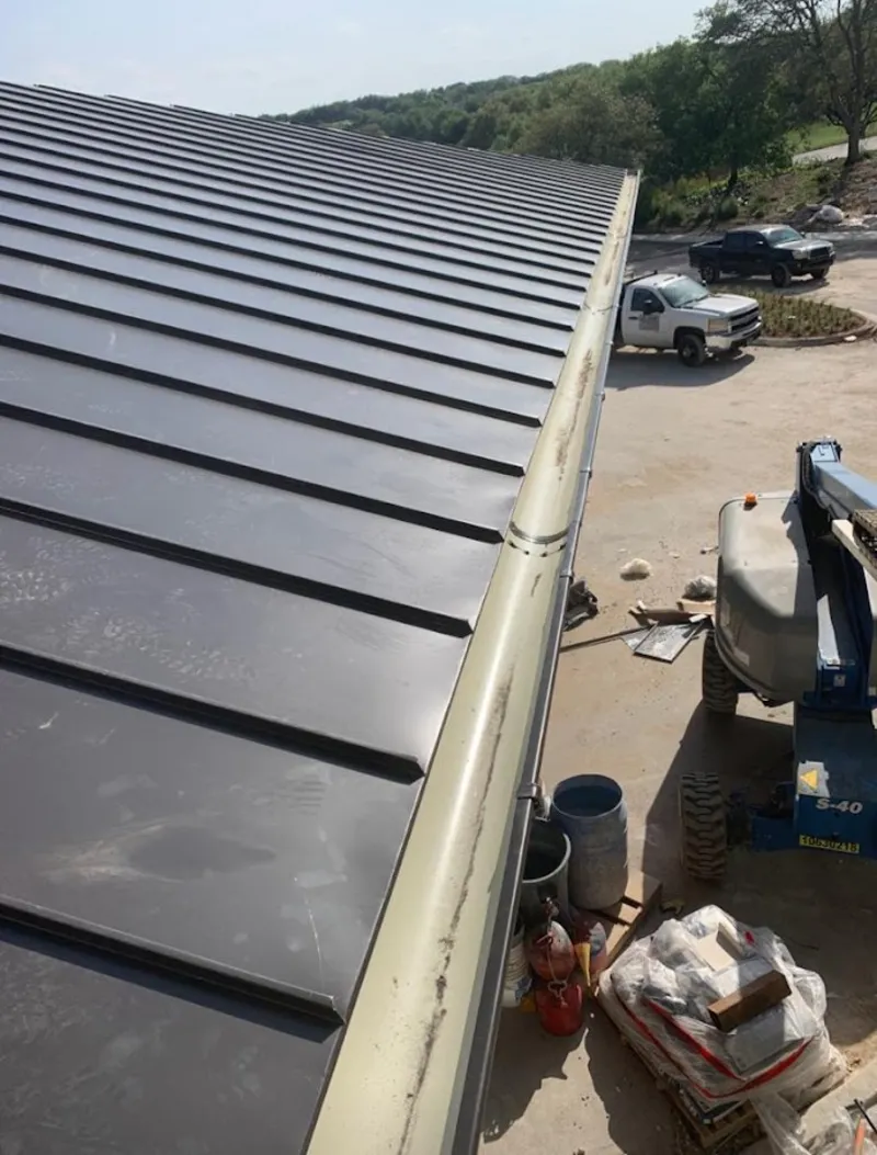 Standing seam panel and gutter detail on a metal roofing jobsite in Wedgefield